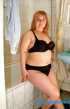 Young plump posing in bathroom