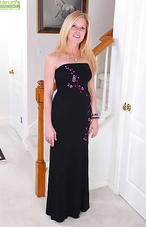 Busty mature Monique slides black dress off her tight body