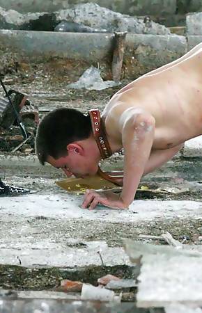 Latex mistress feeds her naked freak somewhere in ruines spitting chewed apple at him