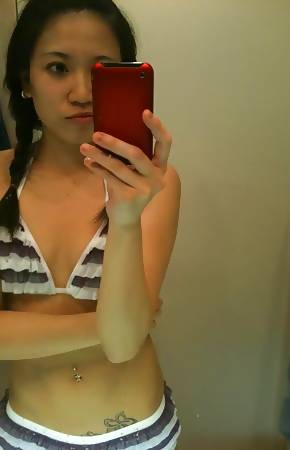Kinky Singaporean babe strips naked while posing sleazy