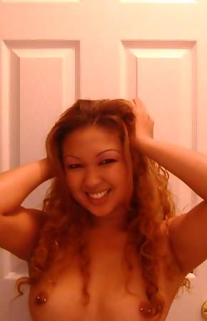 Wild Asian babe with pierced tits posing sexy