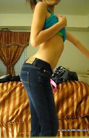 Naughty Asian babe posing sexy in the bedroom