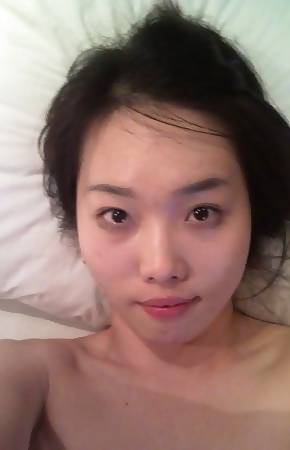 Collection of a horny Asian chick posing naked on the bed