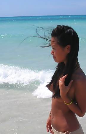 hot and sexy Asian cutie on vacation at a beautiful beach
